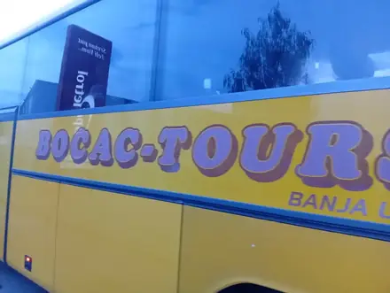 What to look for at the roadside: yellow, purple lettering, blue window band