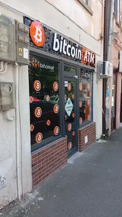 Bitomat: a whole shop unit for one machine, open around the clock, with a security firm’s sticker on the door