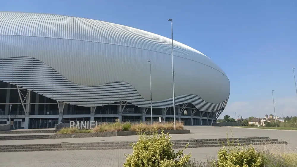 The long side from the forecourt steps — the shell reads as one continuous curve