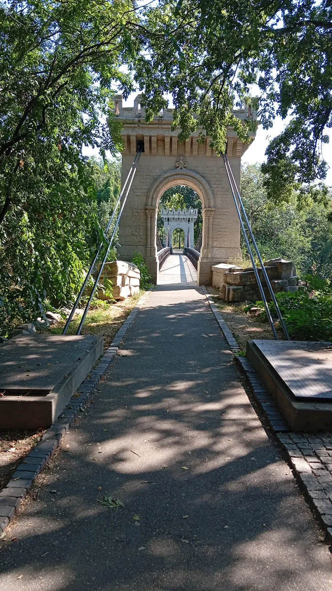 The stone tower at the near end of the bridge