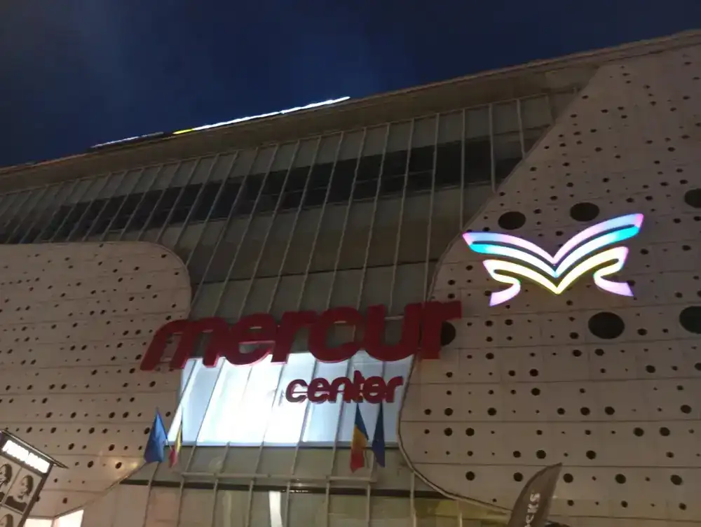 The Mercur sign and its butterfly, lit after dark