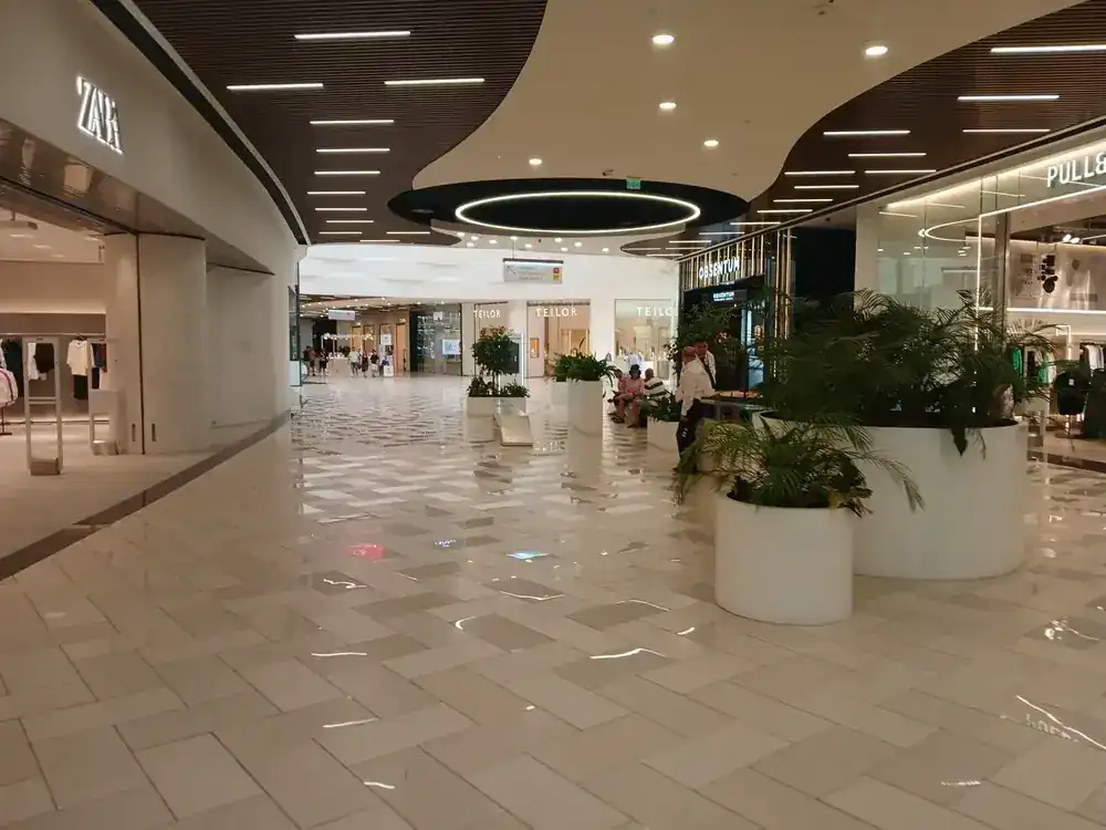 The wide end of the ground floor, planters and benches between the shopfronts