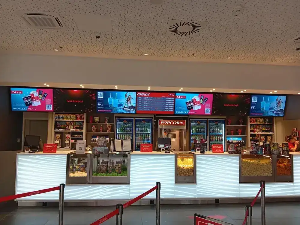 The concession counter — popcorn machine, fridges and the menu screens above