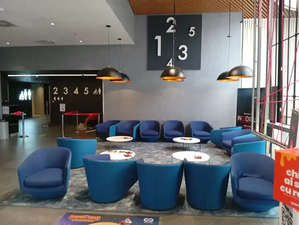 The foyer seating, with the numbered screens signed off it