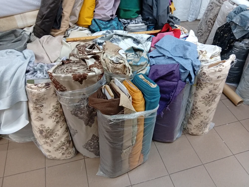 Fabric bolts stood on end in bags, cut to length off the roll