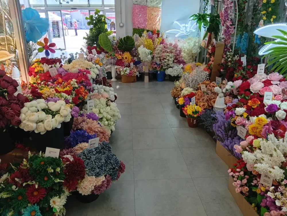 A unit given over to artificial flowers, priced on cards through the display