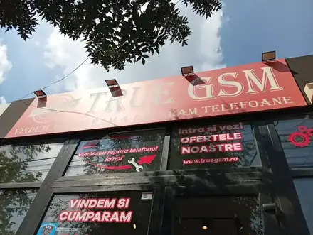 The red True GSM signage over the black shopfront on Bulevardul Carol I, Craiova