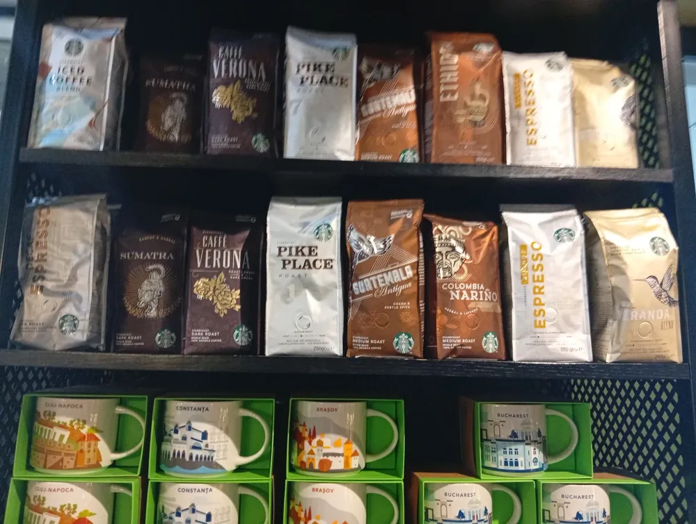 Whole beans on the shelf, and the Romanian city mugs