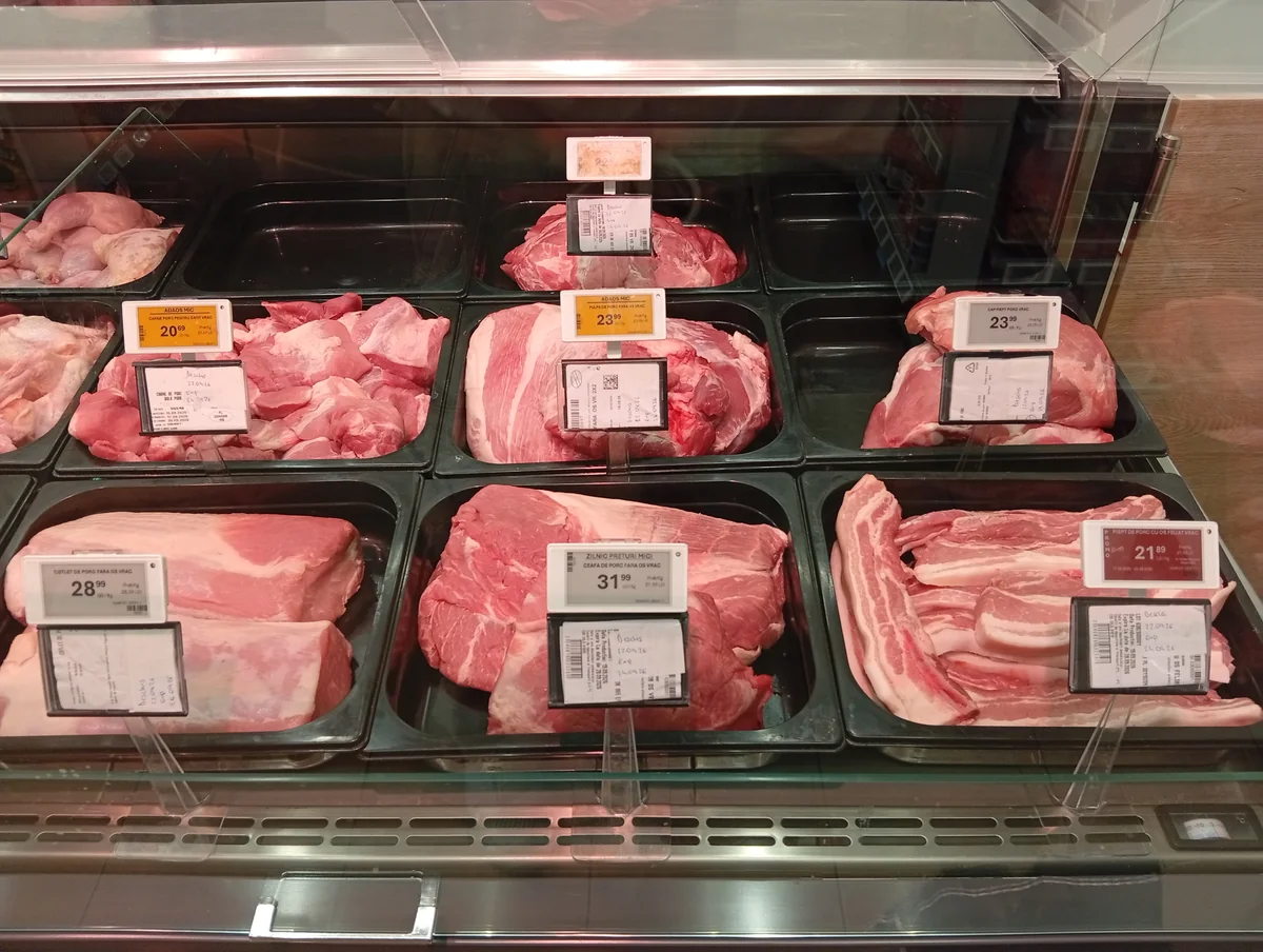 Pork counter at Profi Super, Strada Henry Ford, Craiova area: pork neck, pork loin, boneless pork leg and sliced pork belly with price labels in lei per kg, 22 September 2026