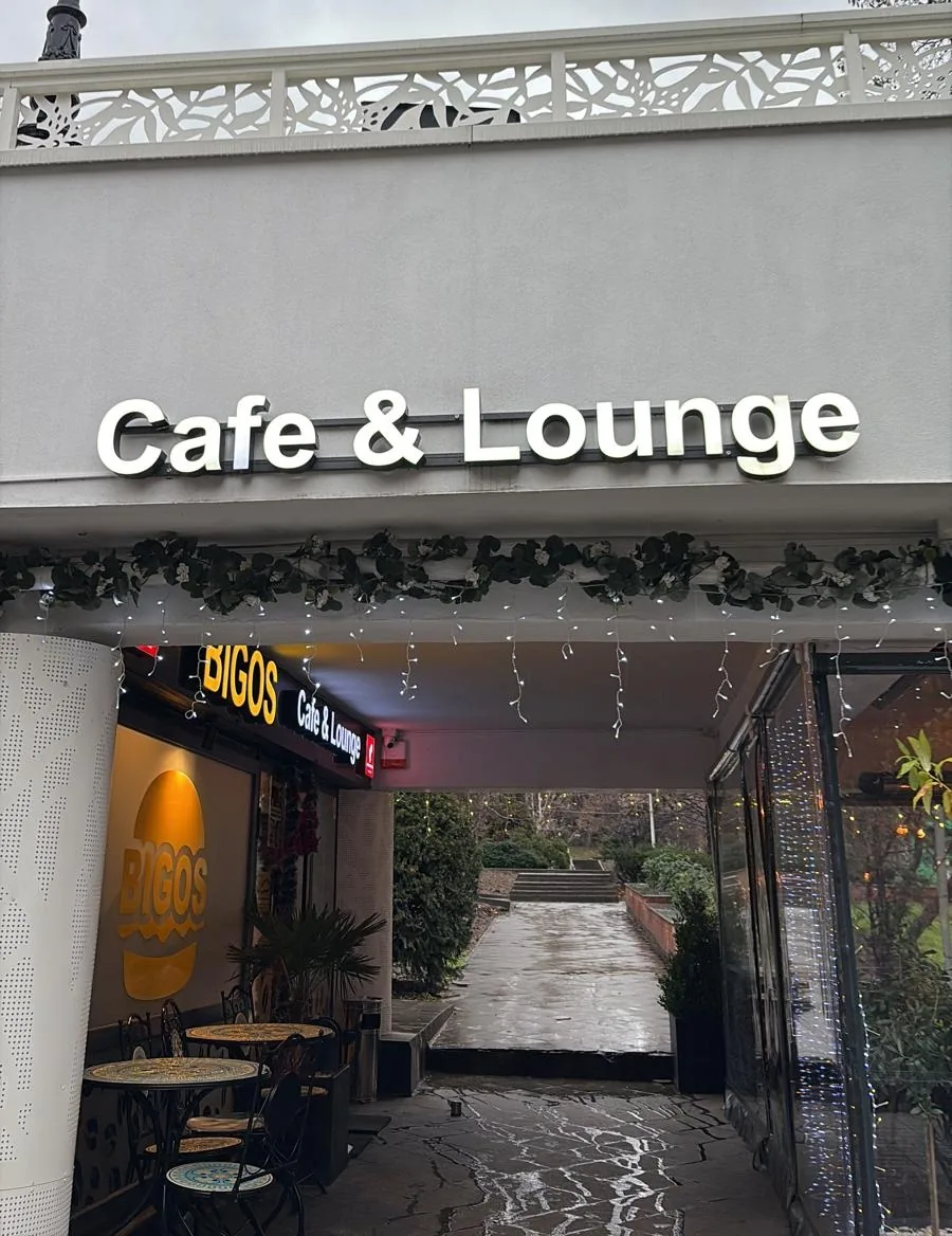 The way in: under the Cafe & Lounge sign, with the path through to the park behind