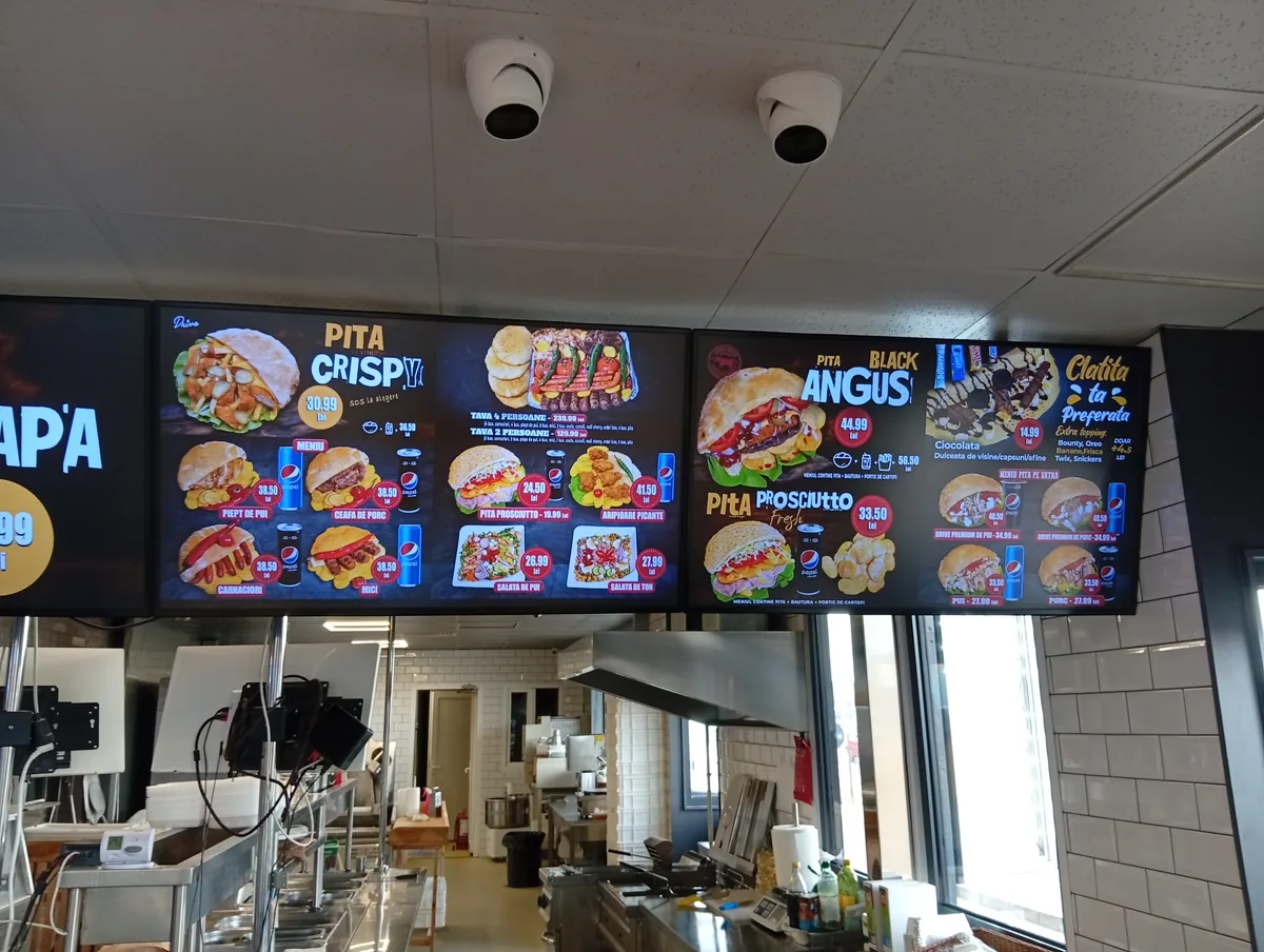 Menu screens at Drive Grill, Craiova: Pita Crispy, Black Angus pita, grill trays for 2 and 4, salads and pancakes with prices in lei, 22 September 2026