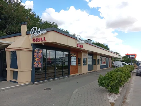 Drive Grill restaurant on Strada Mihai Viteazul, Craiova: drive-thru building with order and pick-up windows and a menu board by the door, 22 September 2026