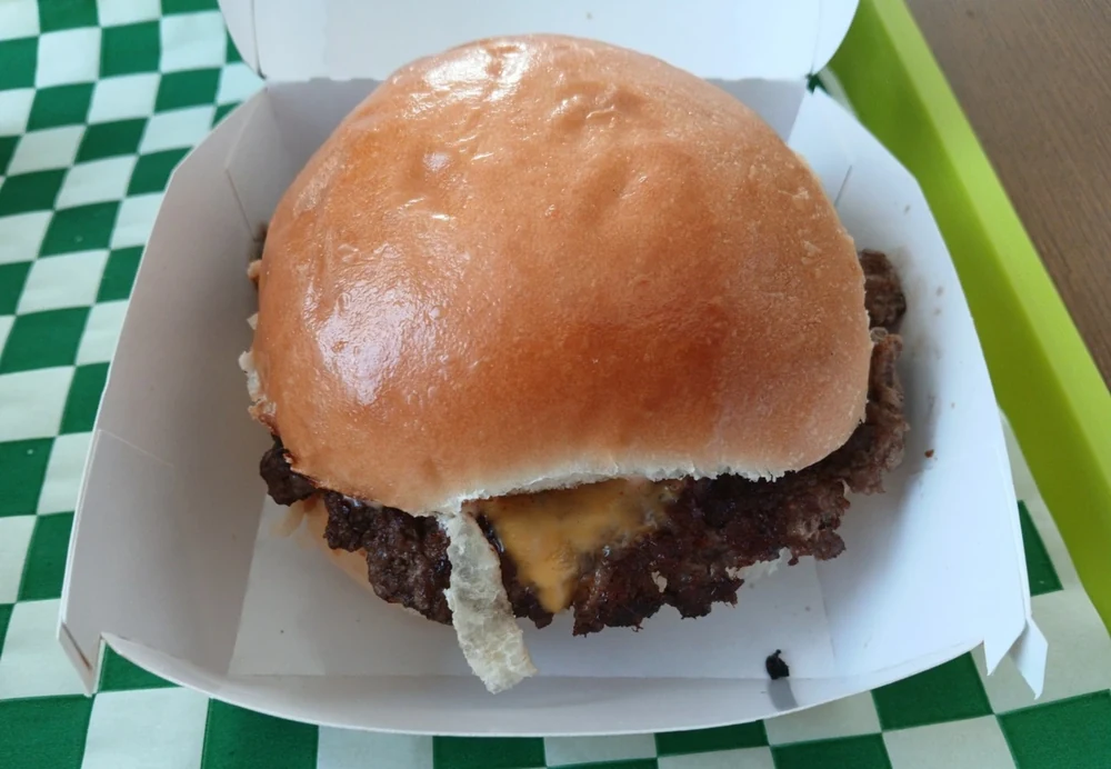 PICK — Smash Burgers, a cheeseburger on the tray. No ticket in shot, so no price — the rest of the page holds to that rule too. September 2026