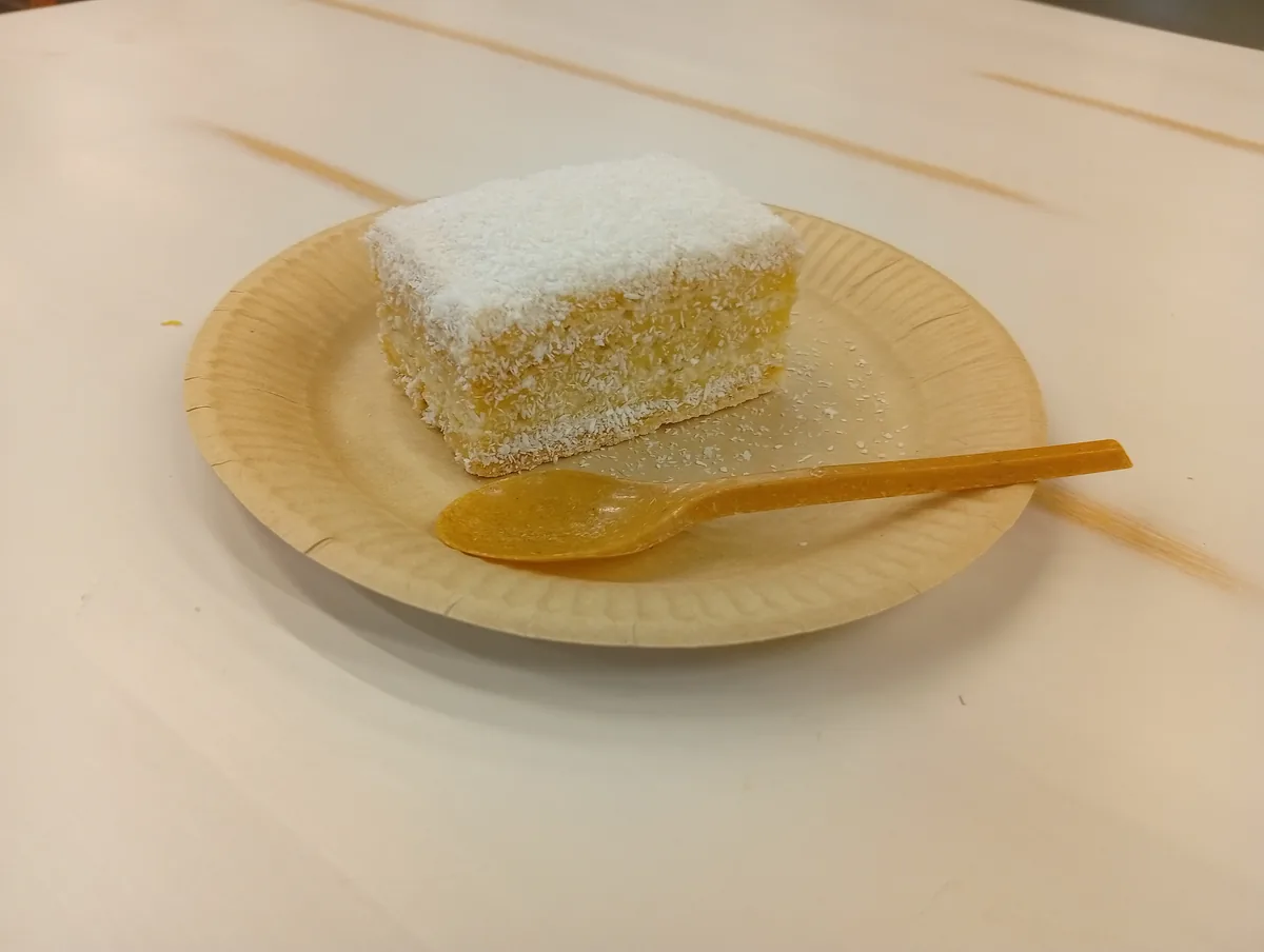 The snack bar in Selgros — Alba ca zapada ("Snow White"), a layered cake rolled in coconut, 10 lei a slice. October 2026