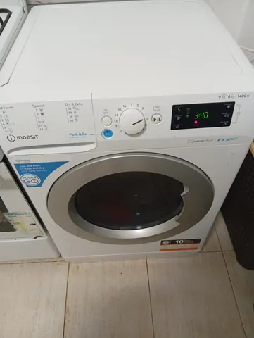 The washer display showing 3:40 and a red lock symbol, laundry visible through the door