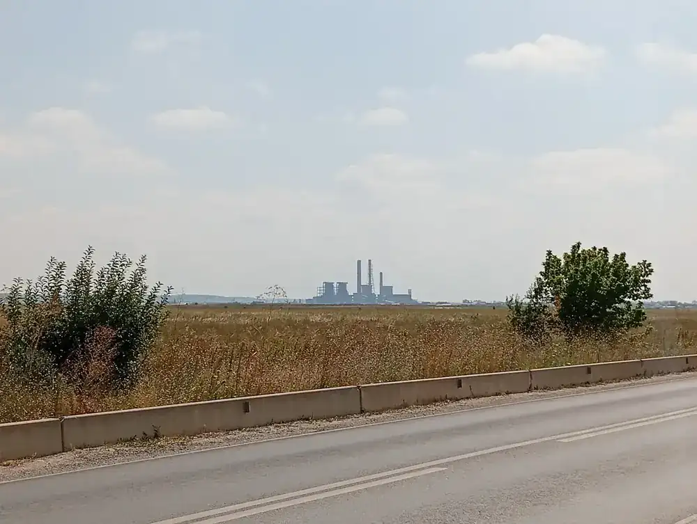 The plain north of the city, the power station standing alone on the horizon